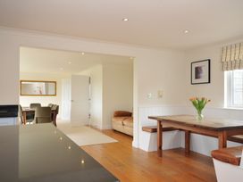 A dining room with a table and chairs at Bodare 8 in Daymer Bay