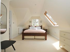 A bedroom with a bed and dresser at Bodare 8 in Daymer Bay