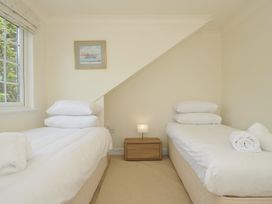 A bedroom with two beds and a nightstand at Bodare 8 Daymer Bay