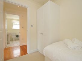 A bedroom with a bed and wardrobe at Bodare 8 Daymer Bay