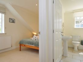 A bedroom with a bed and towels at Bodare 8 in Daymer Bay
