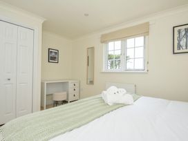 A bedroom with a bed and desk at Bodare 8 in Daymer Bay