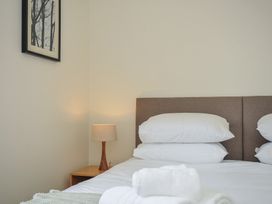 A bedroom with a bed and lamp beside it at Bodare 8 Daymer Bay