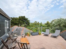 An outdoor terrace with seating and plants at Bodare 8 in Daymer Bay