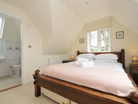 A bedroom with a bed and en-suite bathroom at Bodare 8 Daymer Bay