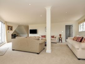 A living room with sofas and a television at Bodare 8 in Daymer Bay