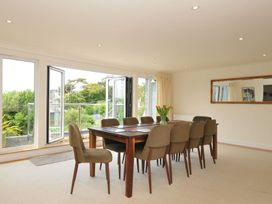 A dining room with a table and chairs at Bodare 8 in Daymer Bay