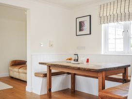A dining area with a table and bench at Bodare 8 Daymer Bay