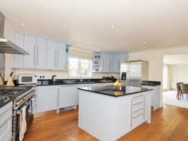 A kitchen with an island and appliances at Bodare 8 in Daymer Bay
