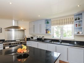 A kitchen with cabinets and appliances at Bodare 8 in Daymer Bay