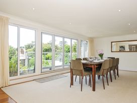 A dining room with a table and chairs at Bodare 8 Daymer Bay