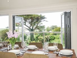 A dining room with a table set for dinner at Bodare 8 in Daymer Bay