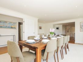 A dining room with a table set for dinner at Bodare 8 in Daymer Bay