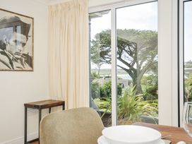 A dining room with a view of the outdoors at Bodare 8 in Daymer Bay