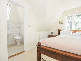 A bedroom with a bed and an attached bathroom at Bodare 8 Daymer Bay