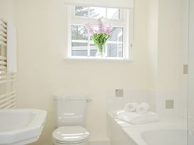 A bathroom with a bathtub and toilet at Bodare 8 in Daymer Bay