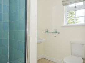 A bathroom with a toilet, sink and shower at Bodare 8 Daymer Bay