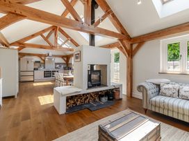 An open plan living area with a kitchen and dining table at Stable Cottage in Burley