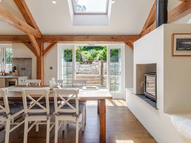A dining room with a table and chairs at Stable Cottage in Burley