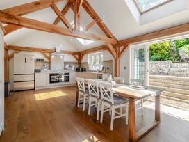 A kitchen with table and chairs at Stable Cottage in Burley
