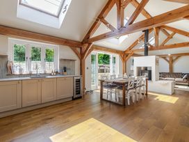 A kitchen with a dining area and a sofa at Stable Cottage in Burley