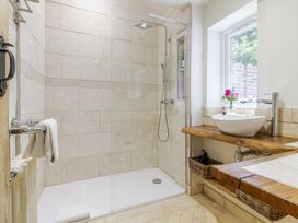 A bathroom with a shower and sink at Stable Cottage in Burley
