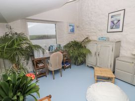An office with a desk and plants at Curlew House in Cosheston