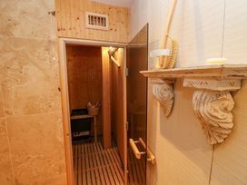 A bathroom with a sauna and shower at Curlew House in Cosheston