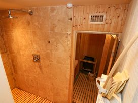 A shower and sauna combination in the bathroom at Curlew House in Cosheston