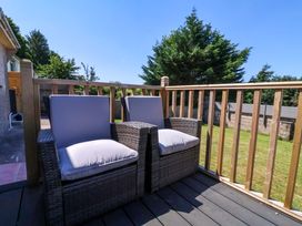 A balcony with two armchairs and trees in the background at West View Northlew near Hatherleigh
