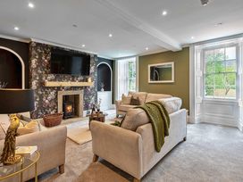 A living room with a fireplace and television at Snowdonia Manor in Dolgellau