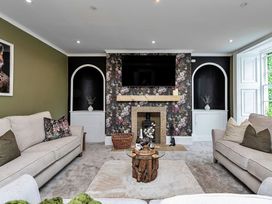 A living room with sofas and a television at Snowdonia Manor in Dolgellau