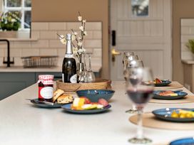 A kitchen with food and drinks arranged on a countertop at Snowdonia Manor in Dolgellau