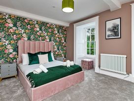 A bedroom with a bed and nightstand at Snowdonia Manor in Dolgellau