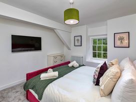 A bedroom with a bed and television at Snowdonia Manor in Dolgellau