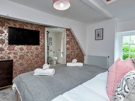 A bedroom with a bed and television at Snowdonia Manor in Dolgellau