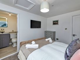 A bedroom with a bed and an attached bathroom at Snowdonia Manor in Dolgellau