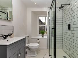 A bathroom with a shower, sink, and toilet at Snowdonia Manor in Dolgellau