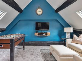 A game room with a foosball table and TV at Snowdonia Manor in Dolgellau