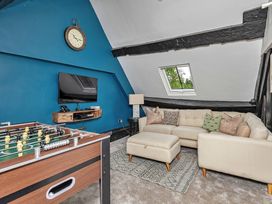 A snug with a foosball table and a television at Snowdonia Manor in Dolgellau