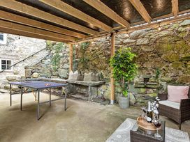 An outdoor patio with a table and chairs at Snowdonia Manor in Dolgellau