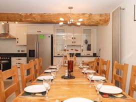 A dining room with a large table and chairs at Swallows Reach in Halwell