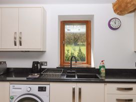 A kitchen with a sink and window at Swallows Reach Halwell