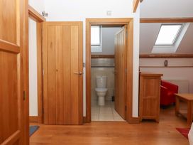 A hallway with doors leading to a bathroom at Swallows Reach Halwell