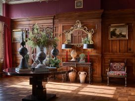 A living room with a wooden table and decorative items at Craig y Don in Glyngarth near Llandegfan