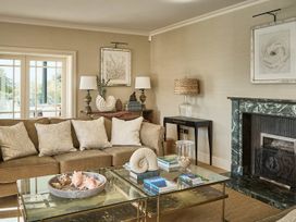 A living room with a sofa and a coffee table at Craig y Don in Glyngarth near Llandegfan