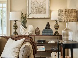A living room with various decorative items and a shelf at Craig y Don Glyngarth near Llandegfan