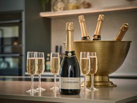 A table with champagne and glasses at Craig y Don in Glyngarth near Llandegfan