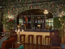 A bar with stools and bottles on display at Craig y Don in Glyngarth near Llandegfan