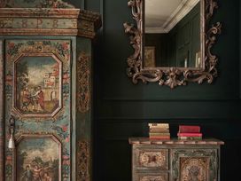 A wardrobe and a mirror with a chest of drawers at Craig y Don Glyngarth near Llandegfan